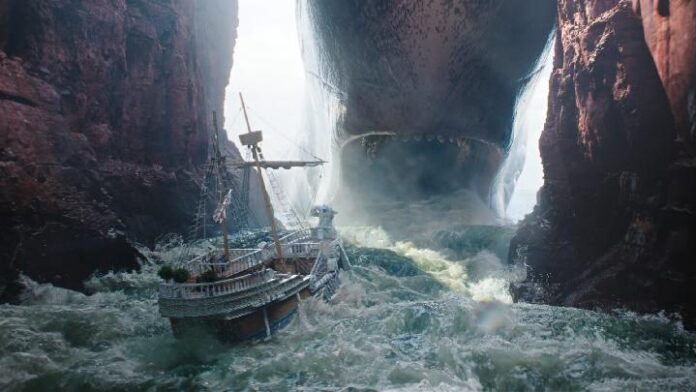 One Piece Season 2 trailer still: kapal Going Merry dihantam arus di celah tebing Grand Line, berhadapan dengan monster laut raksasa.