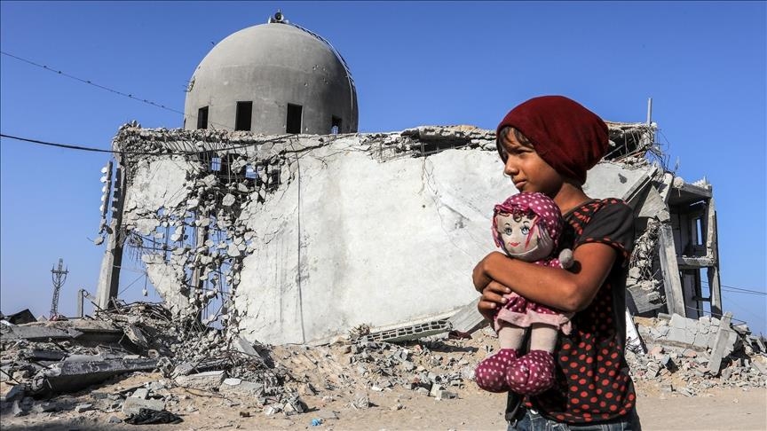 Anak perempuan di Gaza memeluk boneka di depan masjid yang hancur—potret memilukan genosida Gaza.